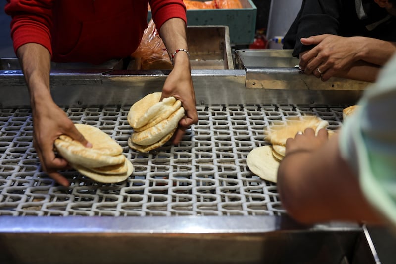Flatbread at a bakery in Gaza city. Bakers are among those who have fled south to Rafah, starting up their businesses there. AFP
