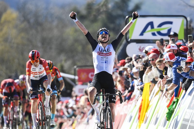 Tadej Pogacar of UAE Team Emirates celebrates as he crosses the finish line to win the 86th Fleche Wallonne one-day race in Belgium on Wednesday, April 19, 2023. AFP