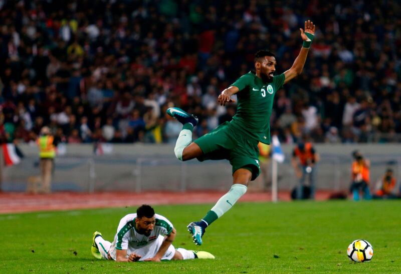 Saudi Arabia's Maath Hasan flies past Iraq's Hussam Kadhem Jaber. Haidar Mohammed Ali / AFP