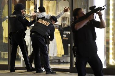 TOPSHOT - Police control a person at Mariahilferstrasse in central Vienna on November 2, 2020, following a shooting near a synagogue. Austrian Interior Minster Nehammer said late on November 2 that a shooting in central Vienna near a major synagogue appeared to be a terrorist attack and was ongoing. - Austria OUT / AFP / APA / ROLAND SCHLAGER