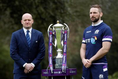 The 6 Nations Scotland Rugby Team coach Gregor Townsend and player John Barclay pose for photographers with the trophy during the Rugby 6 Nations Launch of the tournament in London, Wednesday, Jan. 24, 2018. The Six Nations rugby tournament starts Saturday Feb. 3 and runs until mid-March.(AP Photo/Frank Augstein)