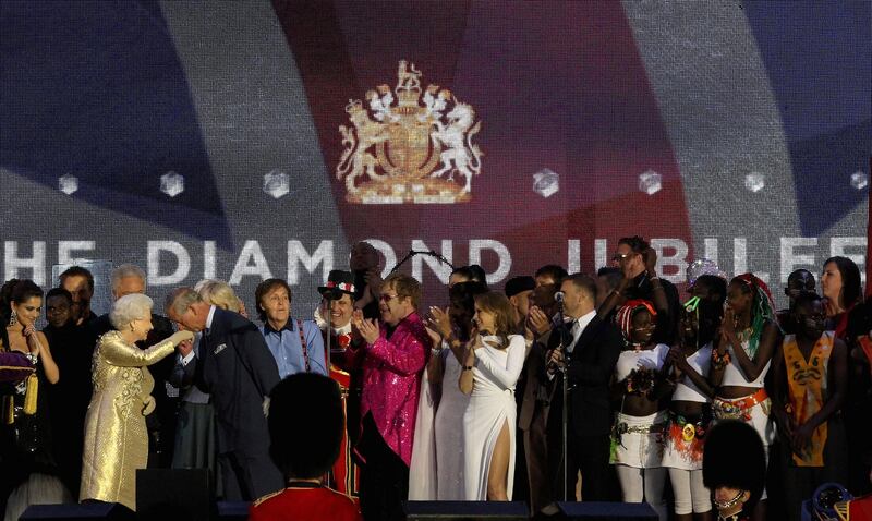 LONDON, ENGLAND - JUNE 04:  HM Queen Elizabeth II and The Prince of Wales (L) on stage with artists during the Diamond Jubilee concert at Buckingham Palace on June 4, 2012 in London, England. For only the second time in its history the UK celebrates the Diamond Jubilee of a monarch. Her Majesty Queen Elizabeth II celebrates the 60th anniversary of her ascension to the throne. Thousands of well-wishers from around the world have flocked to London to witness the spectacle of the weekend‚Äôs celebrations.  (Photo by Dan Kitwood/Getty Images)