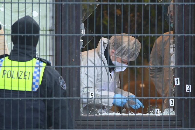 Investigators at the scene after a gunman shot dead six people in the German city of Hamburg. AP 
