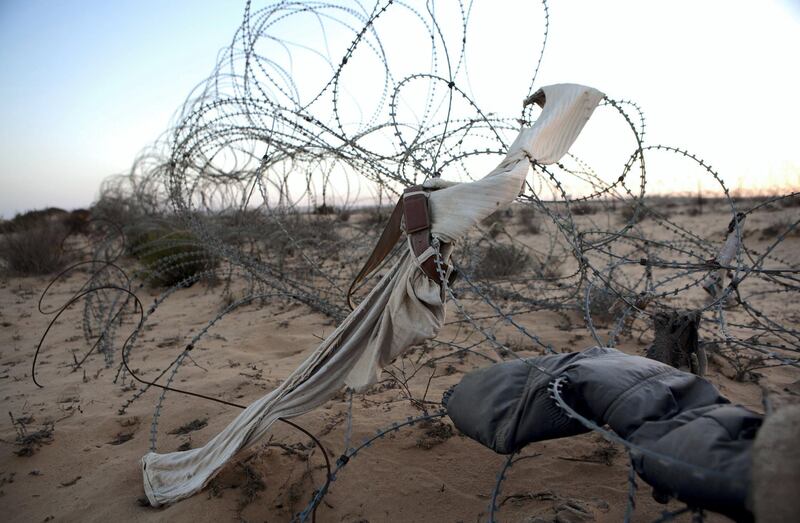 Items of clothing  from African asylum seekers are seen amongst the barbed wire fence along the border between Israel and Egypt on June 9 ,2012. Thousands of migrants  asylum seekers and refugees, primarily from Eritrea and Sudan, have traveled through Egypt and crossed the Sinai border into Israel. Many have lost their lives and have been tortured by Bedouin smugglers. (Photo by Heidi Levine/Sipa Press).//LEVINE_111010287/Credit:Heidi Levine/SIPA/1605172007 *** Local Caption *** 00756072