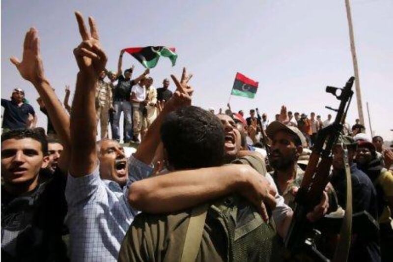 Anti-Gaddafi fighters celebrate as NTC negotiators meet tribal elders from Bani Walid in a mosque near the besieged town city, as talks resume on the peaceful surrender of one of Muammar Qaddafi's last remaining strongholds Youssef Boudlal / Reuters