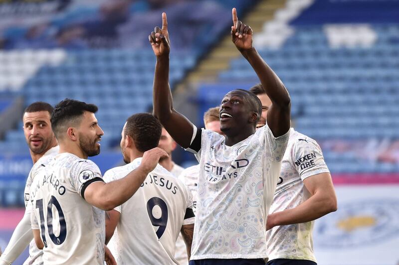 LEICESTER, ENGLAND - APRIL 03: Benjamin Mendy of Manchester City celebrates with Sergio Aguero and teammates after scoring their team's first goal during the Premier League match between Leicester City and Manchester City at The King Power Stadium on April 03, 2021 in Leicester, England. Sporting stadiums around the UK remain under strict restrictions due to the Coronavirus Pandemic as Government social distancing laws prohibit fans inside venues resulting in games being played behind closed doors. (Photo by Rui Vieira - Pool/Getty Images)