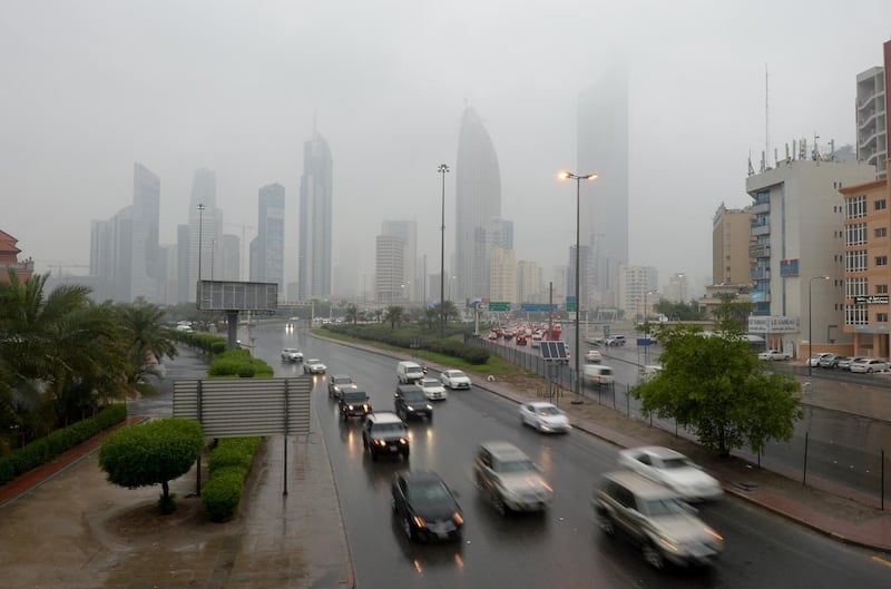 Vehicles drive on a road during rainfall in Kuwait City. EPA