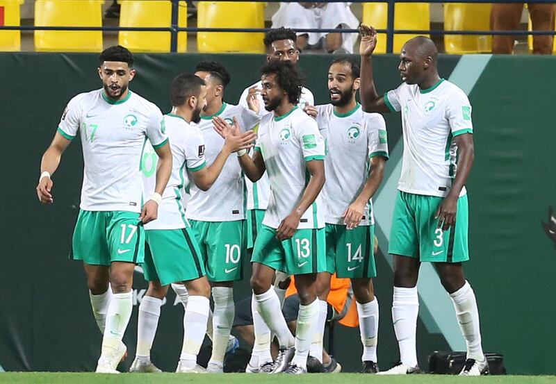 Yasser Al-Shahrani celebrates with teammates after scoring Saudi Arabia's first goal against Palestine. Reuters