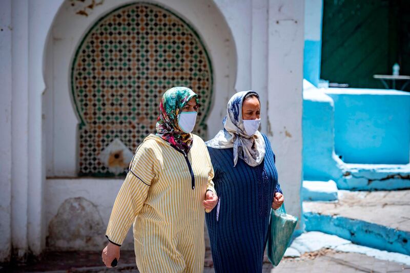 Moroccan women, wearing face masks, walk on a street in Tangiers' Old City, after the announcement of lockdown measures in the northern port city to contain the coronavirus, weeks after easing nationwide restrictions. AFP