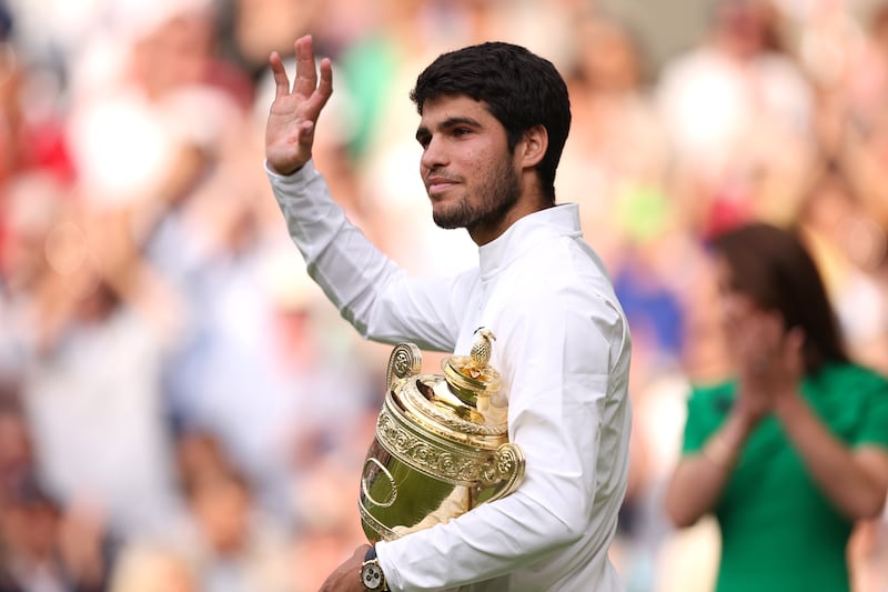 Carlos Alcaraz of Spain lifts the trophy after his victory against Novak Djokovic of Serbia in the men's singles final at Wimbledon on July 16, 2023. PA