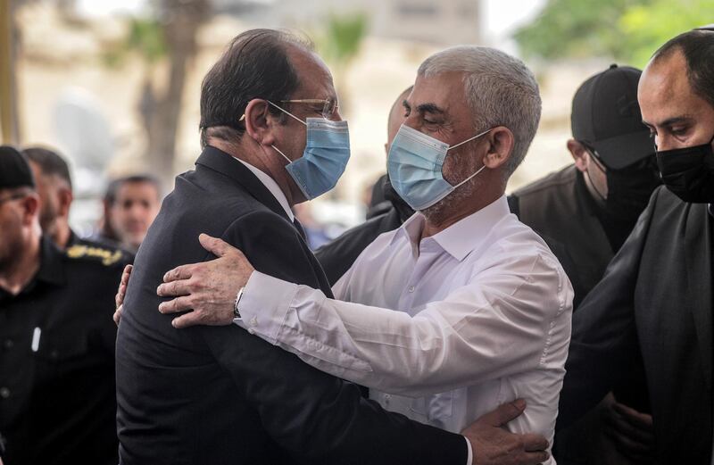 epa09238695 Palestinian Hamas Gaza Chief Yahya Al-Sinwar (R) hugs Director of te Egyptian General Intelligence Directorate, Major General Abbas Kamel as they meet in Gaza,, 31 May 2021. Kamel is on an official visit to Israel and Palestinian territories to follow up on the Egypt-brokered ceasefire agreement between Palestinian armed groups and Israel.  EPA/MOHAMMED SABER