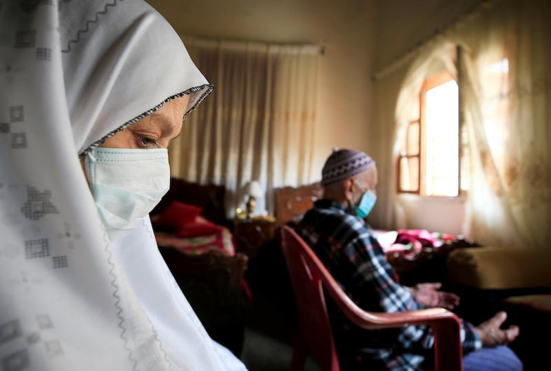 Ahmad al-Asmar, 84, and his wife Nouzat Awada, 79, perform Friday prayers inside their home as mosques are closed over concerns of the spread of coronavirus disease (COVID-19) in Sidon, Lebanon. Reuters