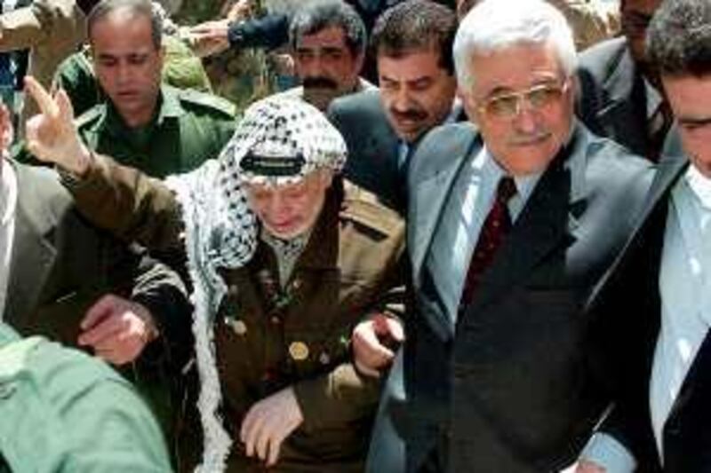Palestinian leader Yasser Arafat (L) and Palestinian Prime Minster-designated, Mahmud Abbas arrive at the Palestinian Legislative Council (parliament), in the West Bank City of Ramalla, 29 April 2003. In a powerful speech to parliament, Abbas vowed to crack down on illegal arms, incitement to violence and corruption, all key steps demanded by Israel as steps to renewing peace talks.  AFP PHOTO/Jamal ARURI