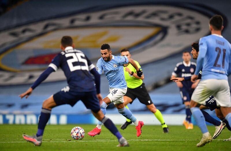 Manchester City's Algerian midfielder Riyad Mahrez (C) runs with the ball during the UEFA Champions League football Group C match between Manchester City and Olympiakos at the Etihad Stadium in Manchester, north west England on November 3, 2020. (Photo by Paul ELLIS / AFP)