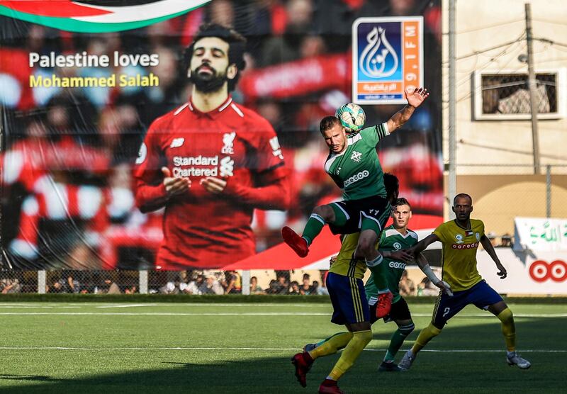 A giant poster showing Liverpool's Egyptian midfielder Mohamed Salah is seen during the first leg match of the Palestine Cup final between Khadamat Rafah Club and Balata Sports Centre, in Rafah in the southern Gaza Strip.  AFP