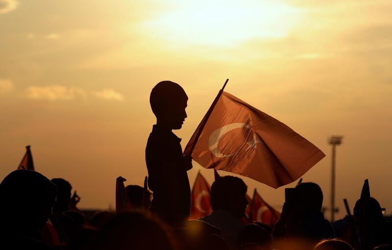 A boy holds a Turkish flag during a rally to honour the victims of the July 15 2016 failed coup attempt. AP Photo