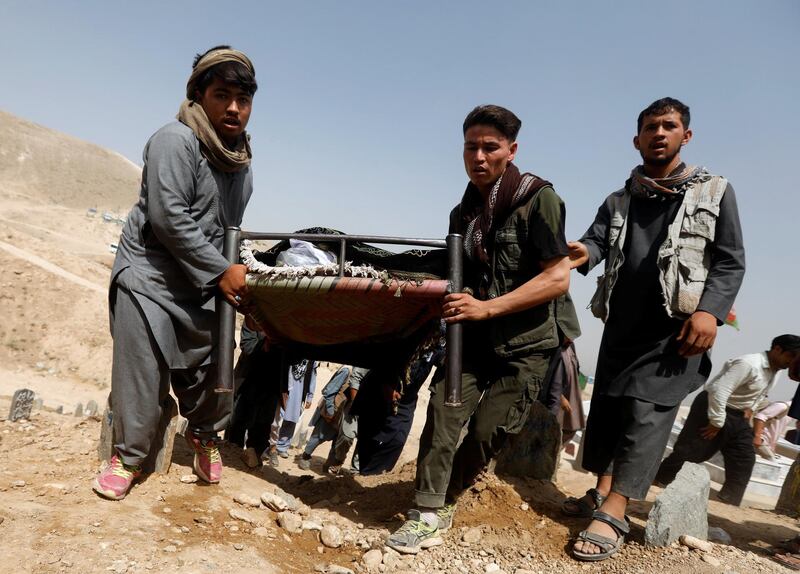 People carry the body of one of the victims of yesterday's suicide attack. Reuters