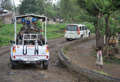 FILE PHOTO: A Congolese girl gestures to peacekeepers from India, serving in the United Nations Organization Stabilization Mission in the Democratic Republic of the Congo (MONUSCO), as they ride on patrol in the town of Kiwanja, Democratic Republic of Congo, October 19, 2018.  Picture taken October 19, 2018.  REUTERS/Oleksandr Klymenko/File Photo