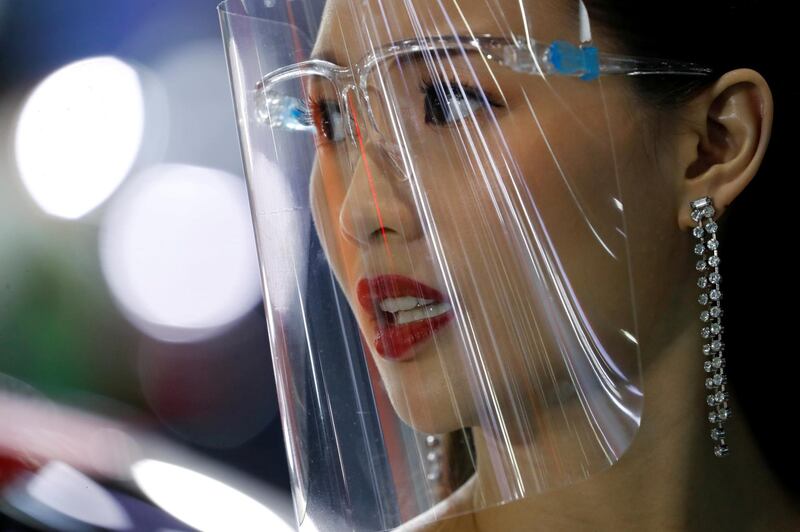 A promoter wears a face shield during the 41st Bangkok International Motor Show after the Thai government eased restrictions imposed to limit the spread of the coronavirus, in Bangkok. Reuters