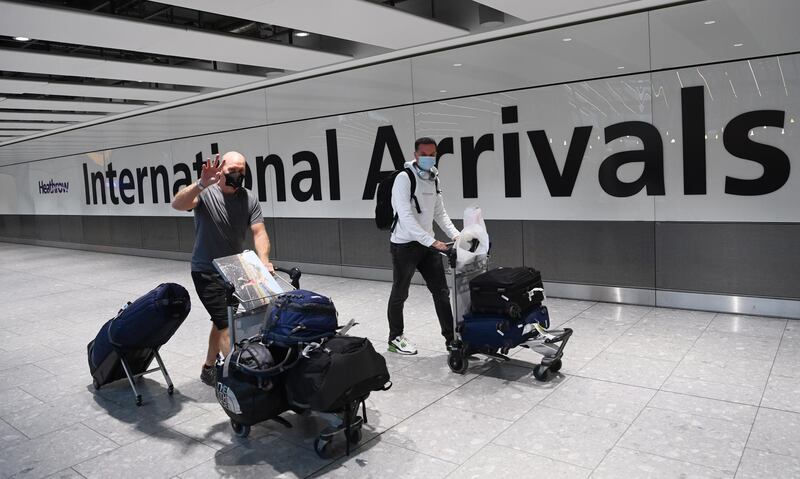 Travellers arrive at Heathrow Airport in London,. The UK government is implementing a closure on all travel corridors from Monday 18 January. EPA