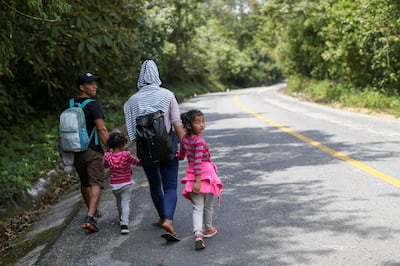 A Honduran migrant family trying to reach the U.S. walks on a highway on the outskirts of Palenque, Mexico March 8, 2021. Picture taken March 8, 2021. REUTERS/Edgard Garrido