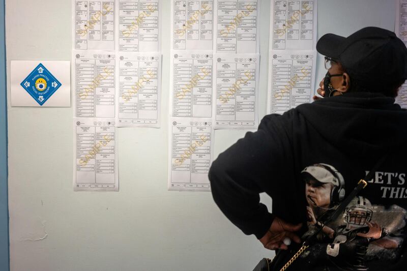 A woman looks at sample ballots while waiting at City Hall to cast her ballot for the upcoming presidential election as early voting begins in New Orleans, Louisiana. Reuters