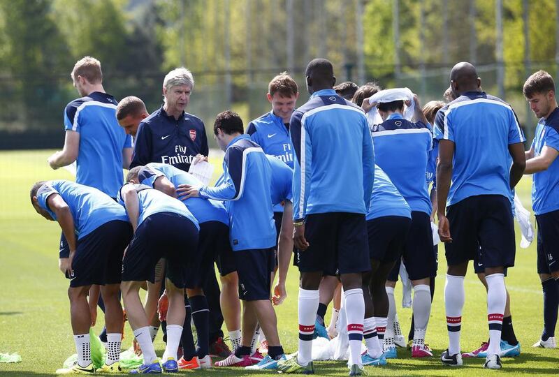 Arsenal manager Arsene Wenger talks to his players before a training session on Wednesday as they prepare to face Hull City in the FA Cup final on Saturday. Eddie Keogh / Reuters / May 14, 2014