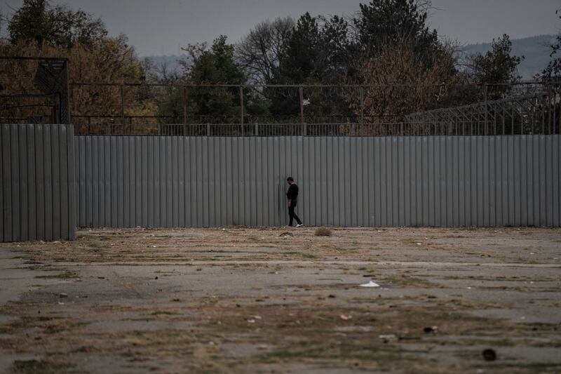 A migrant next to the wall of the Harmanli migrant processing camp, Bulgaria's largest. Getty
