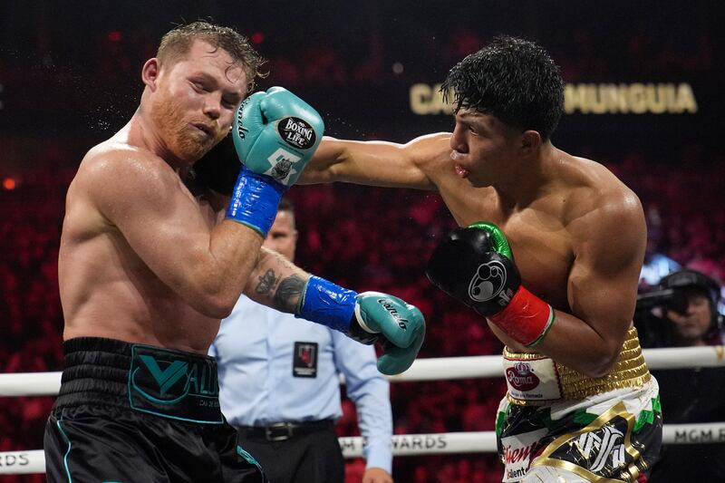 Jaime Munguia lands a punch on Canelo Alvarez. AP