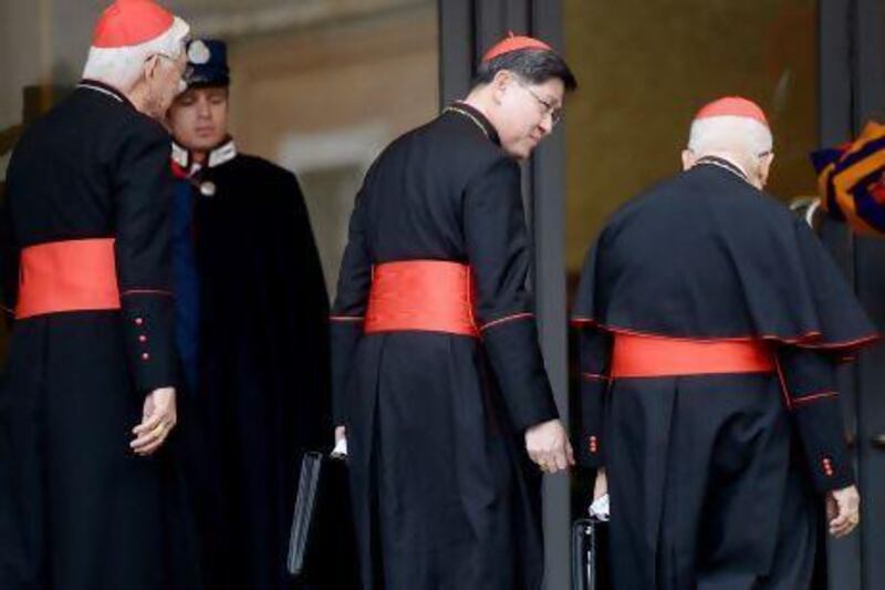 Philippine cardinal Luis Antonio Tagle (centre) arrives for an afternoon meeting of the pre-conclave at the Vatican.