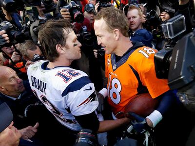 FILE - In this Jan. 24, 2016, file photo, New England Patriots quarterback Tom Brady, left, and Denver Broncos quarterback Peyton Manning speak to one another following the NFL football AFC championship game in Denver. Tiger Woods and Phil Mickelson are ready for a made-for-TV rematch at a time when fans are craving live action. And this time, they'll have company. Turner Sports says Brady and Manning will join them for a two-on-two match sometime in May. Missing from the announcement were such details as when and where the match would be played, except that tournament organizers would work with government and health officials to meet safety and health standards. (AP Photo/David Zalubowski, File)