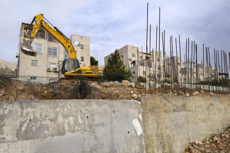 Earth moving equipment stands in the Israeli settlement of Ramat Shlomo near Jerusalem. Jim Hollander / EPA