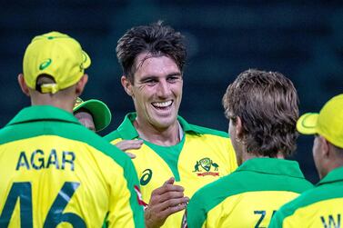 FILE - In this Feb. 21, 2020, file photo, Australia's bowler Pat Cummins, middle, celebrates with teammates during the 1st T20 cricket match between South Africa and Australia at Wanderers stadium in Johannesburg, South Africa. Australia's cricketers will show their support for the Black Lives Matter movement by forming a barefoot circle on the field before their first limited-overs international against India in Sydney later this month. Australia vice-captain Pat Cummins says the players hadn't done enough in the past and “we want to get better." (AP Photo/Themba Hadebe, File)