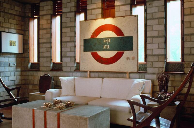 Artwork styled on London Underground logo above white sofa in modern sitting room.