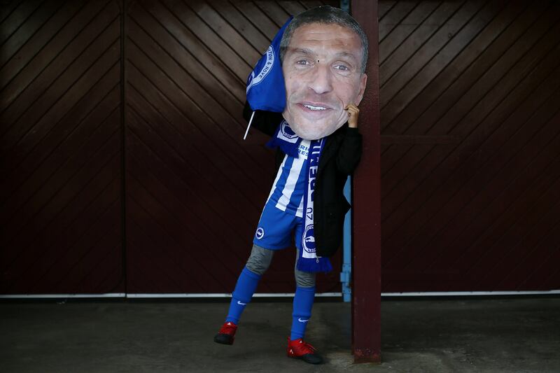 A Brighton & Hove Albion football fan wears a mask of the club’s manager — Chris Hughton — before their final game of the season against Aston Villa. Jan Kruger / Getty Images