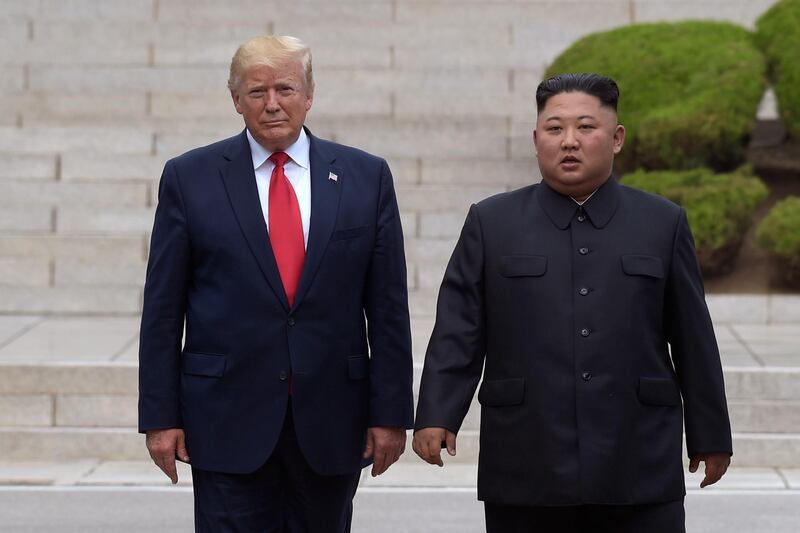 FILE - In this June 30, 2019, file photo, President Donald Trump, left, meets with North Korean leader Kim Jong Un at the North Korean side of the border at the village of Panmunjom in Demilitarized Zone. North Korea threatened Thursday, Dec. 5, to resume insults of Trump and consider him a â€œdotardâ€ if he keeps using provocative language. (AP Photo/Susan Walsh, File)