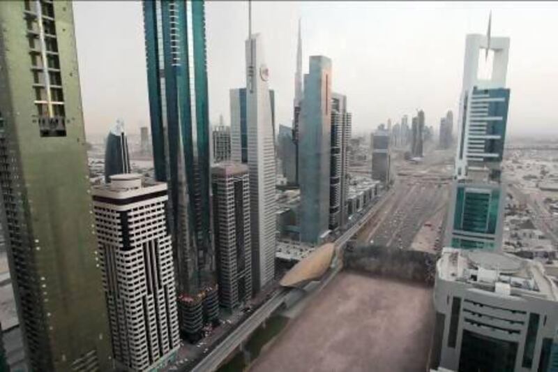 A computer-generated image from the television show Strip the City, shows Sheikh Zayed Road in Dubai being rolled up like a carpet to reveal deep sand beneath. Courtesy Discovery Channel