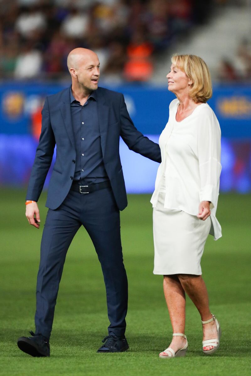 Jordi Cruyff and his mother Danny Coster walk onto the pitch. Getty