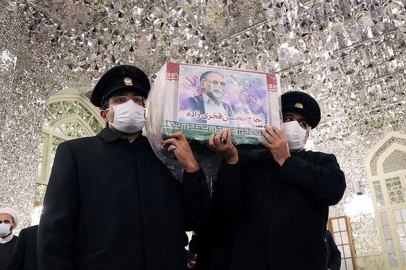 Servants of the holy shrine of Imam Reza carry the coffin of Iranian nuclear scientist Mohsen Fakhrizadeh in Mashhad, Iran. WANA via REUTERS