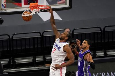 Los Angeles Clippers forward Kawhi Leonard dunks past Sacramento Kings guard Justin James, right, during the second half of an NBA basketball game in Sacramento, Calif., Friday Jan. 15, 2021. The Clippers won 138-100. (AP Photo/Rich Pedroncelli)