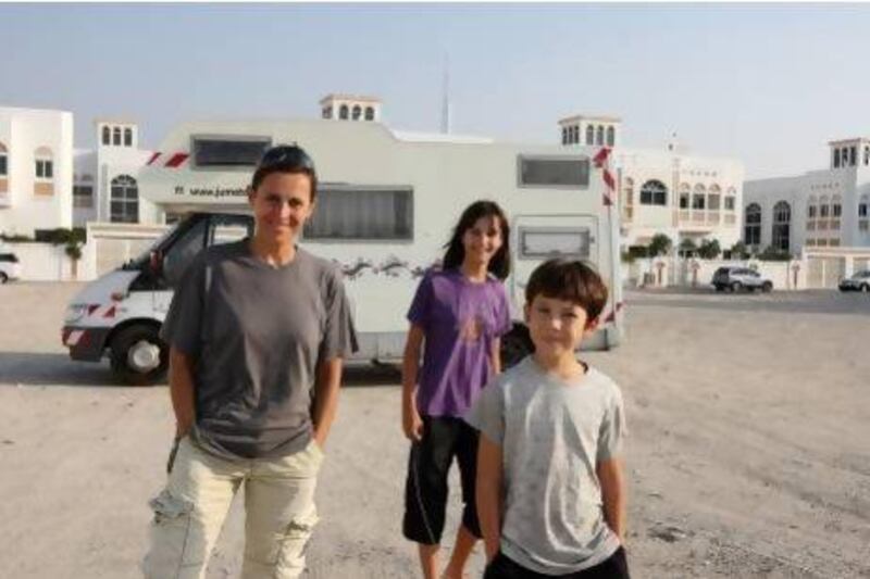 Christine Alessandrini, 42, along with Julie, 12, and Thomas, 10, with the caravan near Jumeirah open beach opposite Dubai zoo. Pawan Singh / The National