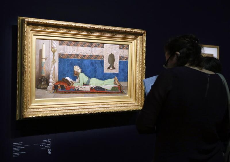 A woman looks at a painting by Osman Hamdi Bey entitled ‘The young emir studying’ (Istanbul, 1878). Francois Guillot/AFP