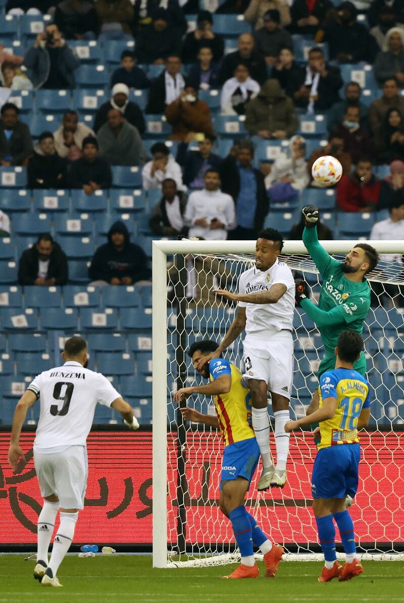 Valencia goalkeeper Giorgi Mamardashvili jumps for the ball with Madrid's Brazilian defender Eder Militao. AFP