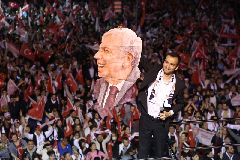 A man holds a portrait of Mr Yavas in Ankara. AFP