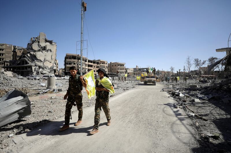Fighters of Syrian Democratic Forces walk along a street in Raqqa on October 17, 2017. Rodi Said / Reuters