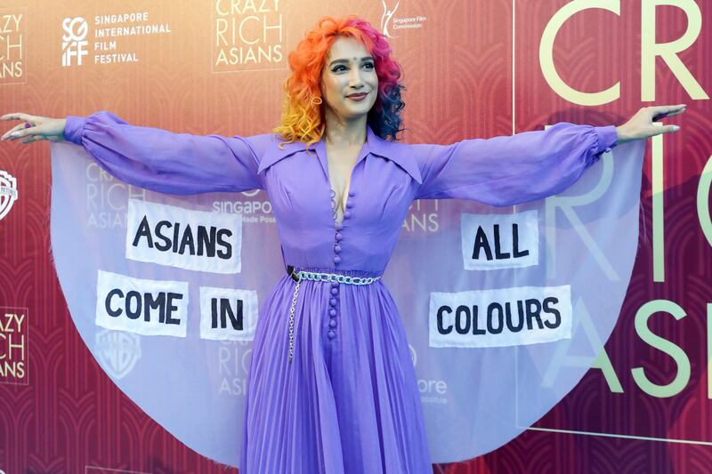 Burlesque performer Sukki Singapora poses for photographers as she arrives for the red carpet screening of the movie 'Crazy Rich Asians' on August 21, 2018, in Singapore. Don Wong / AP photo