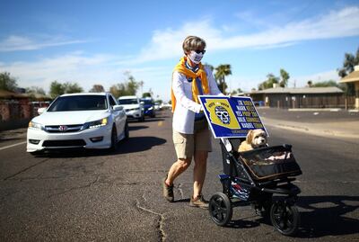 A woman pushes her dog in a pram as she takes part in an event to promote the importance of the Latino vote and support for Democratic U.S. presidential nominee Joe Biden, in the majority Hispanic neighbourhood of Maryvale in Phoenix, Arizona U.S., October 31, 2020. REUTERS/Edgard Garrido