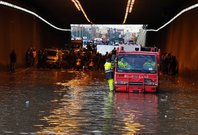 A Civil Defense vehicle drives through a flooded tunnel, as motorists along with their vehicles are stranded, in Beirut's southern suburb of Ouzai. AP Photo