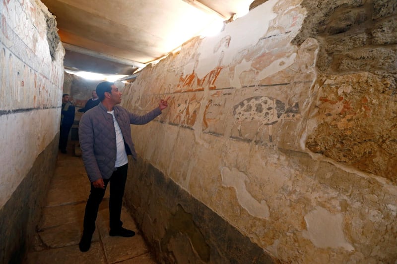 A guide from the Ministry of Antiquities inspects a discovery tomb of a priestess named "Hetpet" belonging to a fifth dynasty in Old Kingdom at the Giza plateau, the site of the three ancient pyramids on the outskirts of Cairo, Egypt February 3, 2018. REUTERS/Amr Abdallah Dalsh