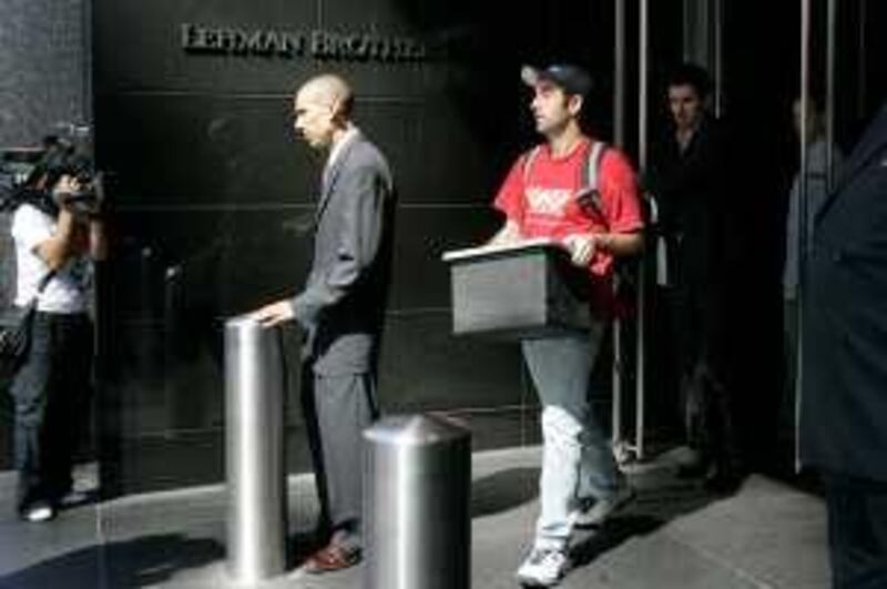 A man leaves the Lehman Brothers headquarters carrying a box,  Monday, Sept. 15, 2008 in New York. Lehman Brothers, a 158-year-old investment bank choked by the credit crisis and falling real estate values, filed for Chapter 11 protection in the biggest bankruptcy filing ever on Monday and said it was trying to sell off key business units. (AP Photo/Mary Altaffer)